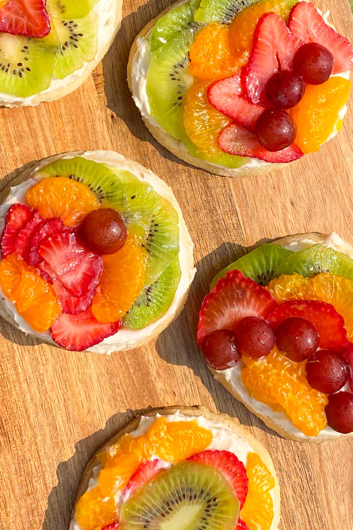 Sugar cookies topped with cream cheese and fresh fruit.