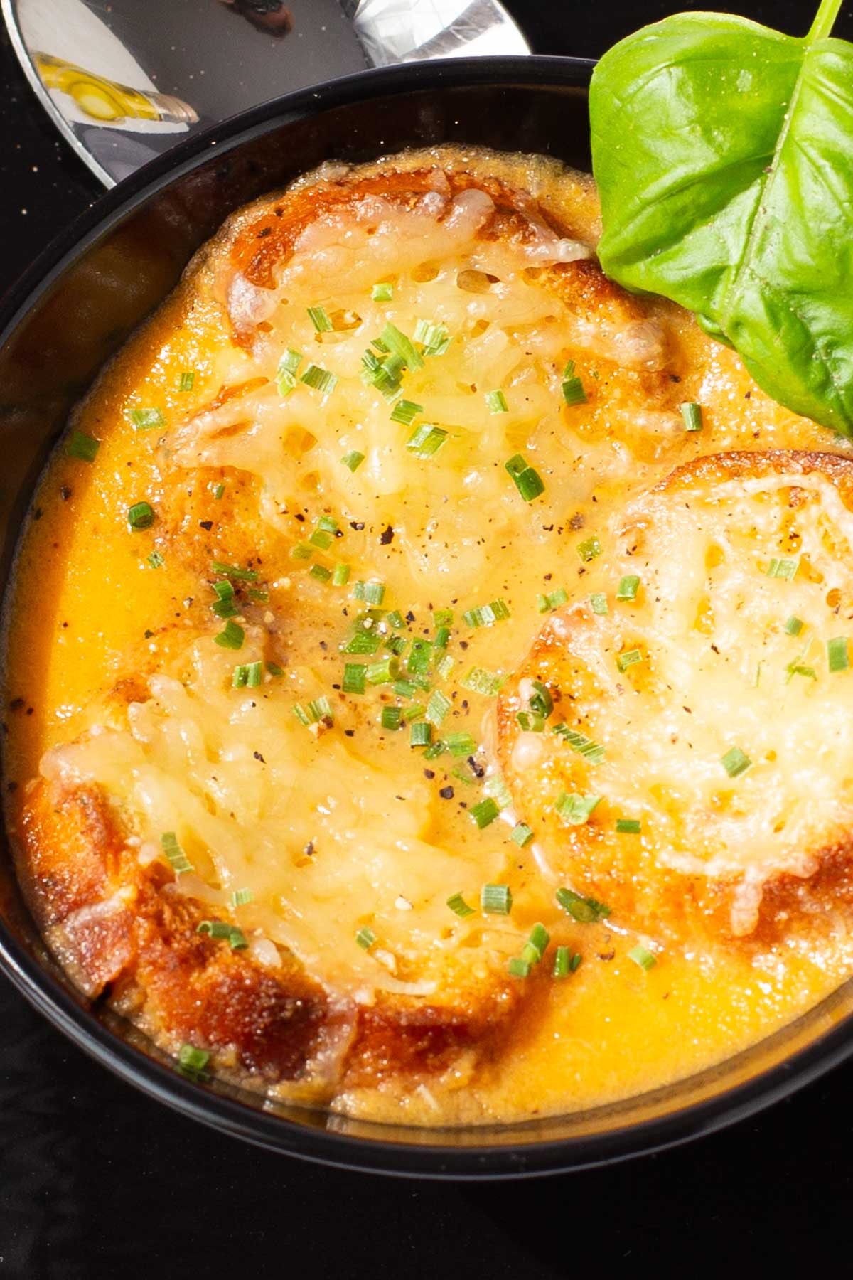 Tomato soup topped with toasted crostinis and parmesan cheese.