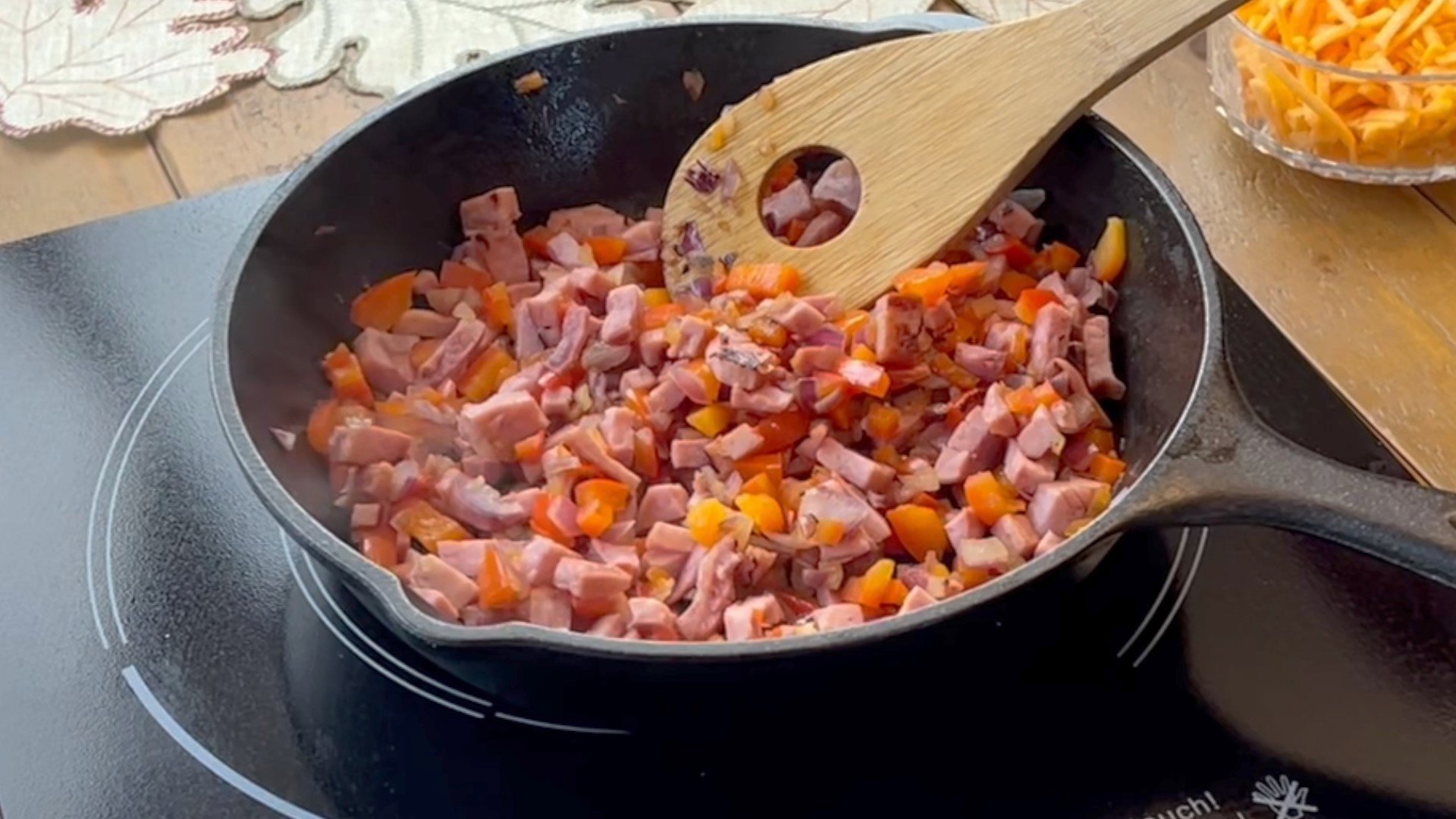 Cast iron skillet of sautéed ham, red peppers and onion.