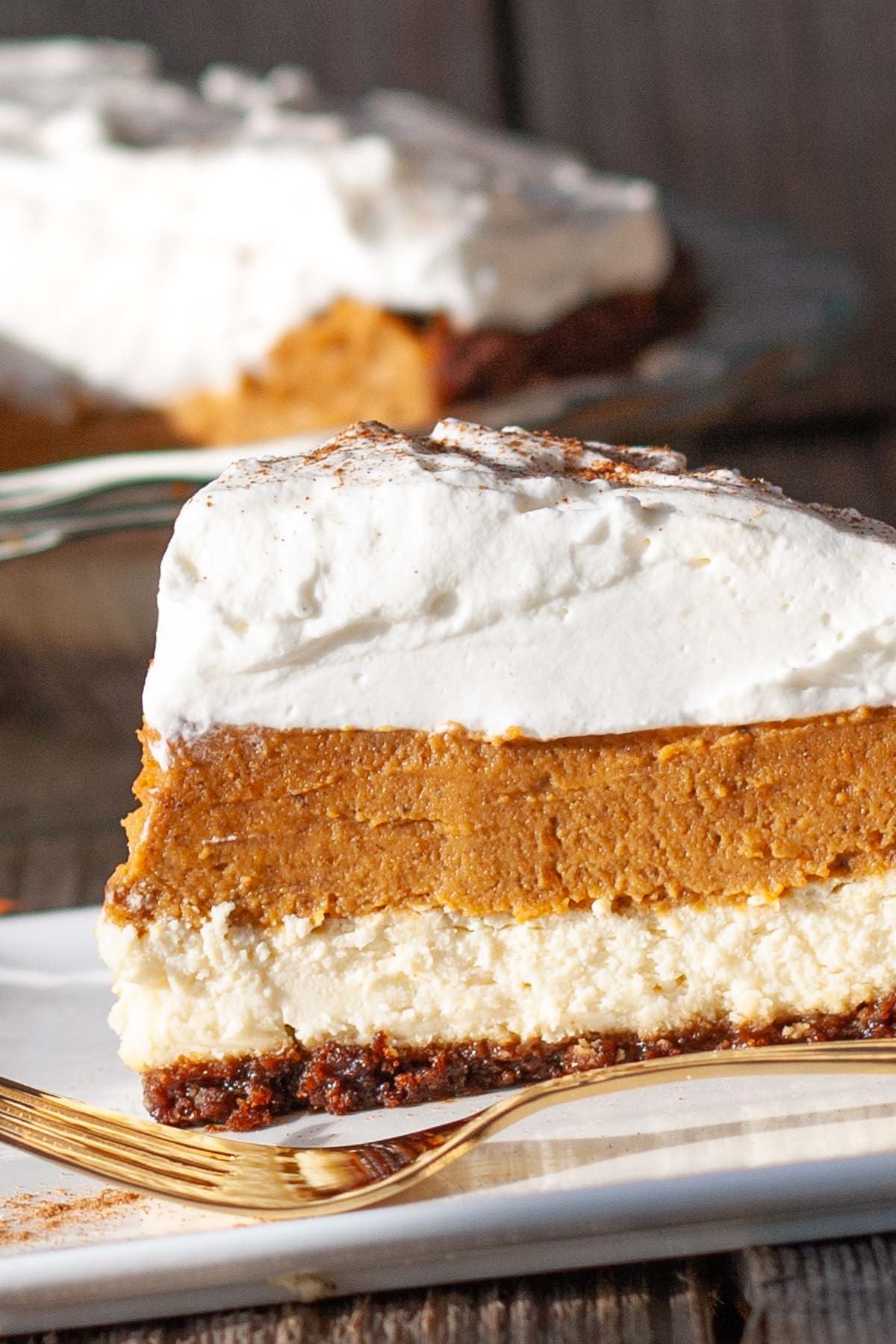 Cream cheese and pumpkin layered pie topped with whipped cream.