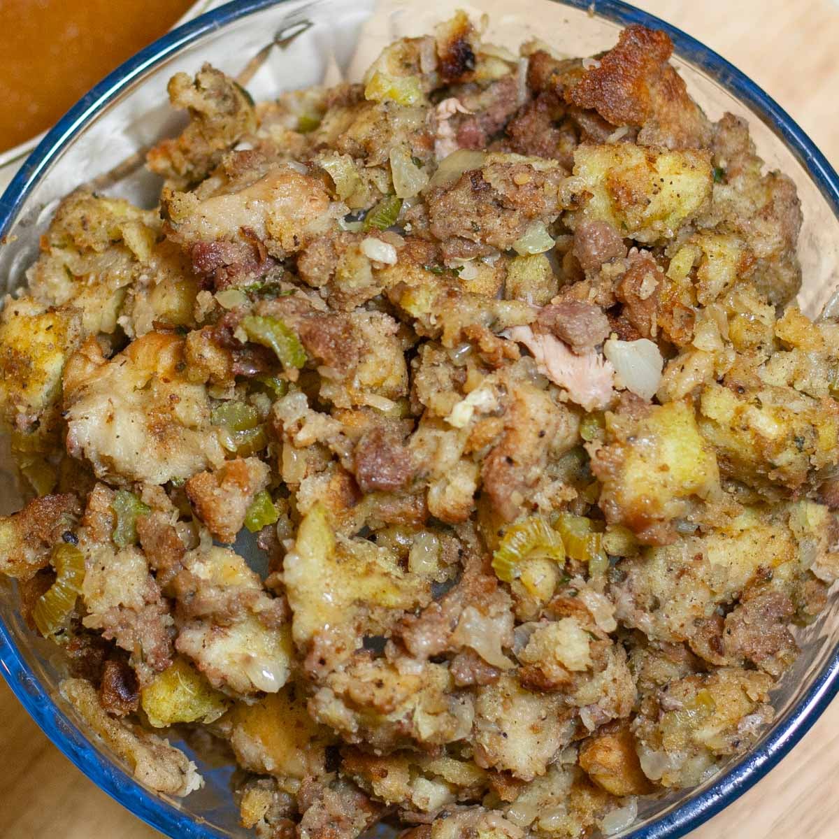 Glass bowl filled with turkey stuffing.