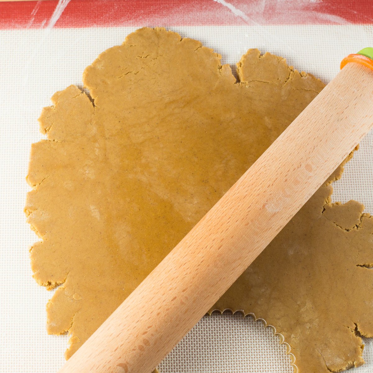 Gingerbread dough rolled out with wood rolling pin.