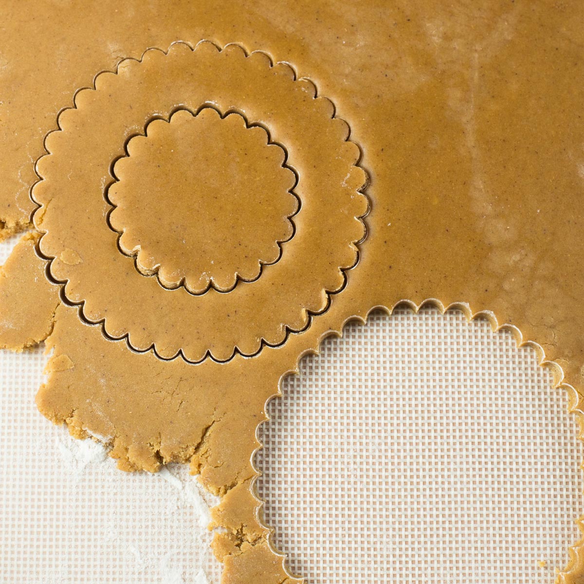 Gingerbread dough with circle shapes cut out.