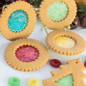 Circle and Christmas tree shaped ginger bread cookies with melted candy center.