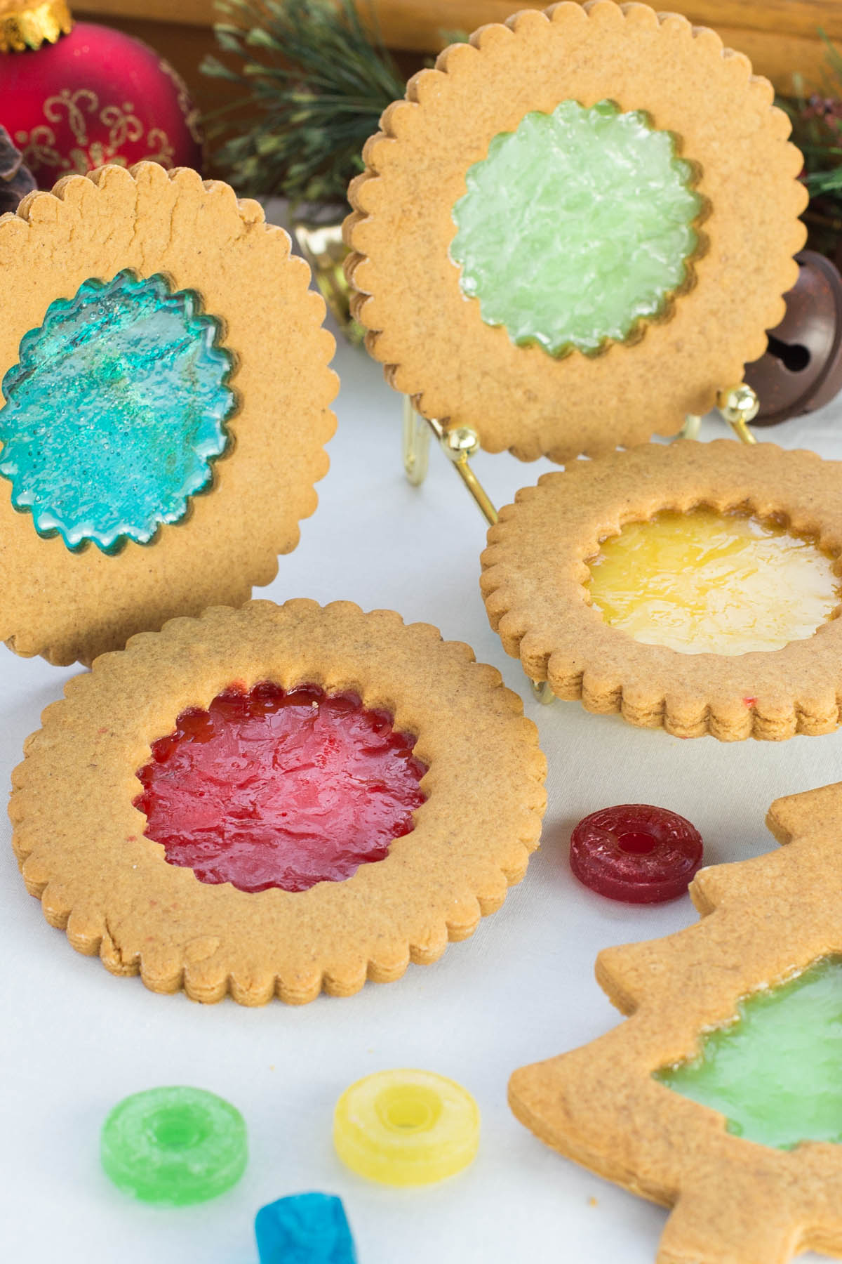 Circle and Christmas tree shaped ginger bread cookies with melted candy center.