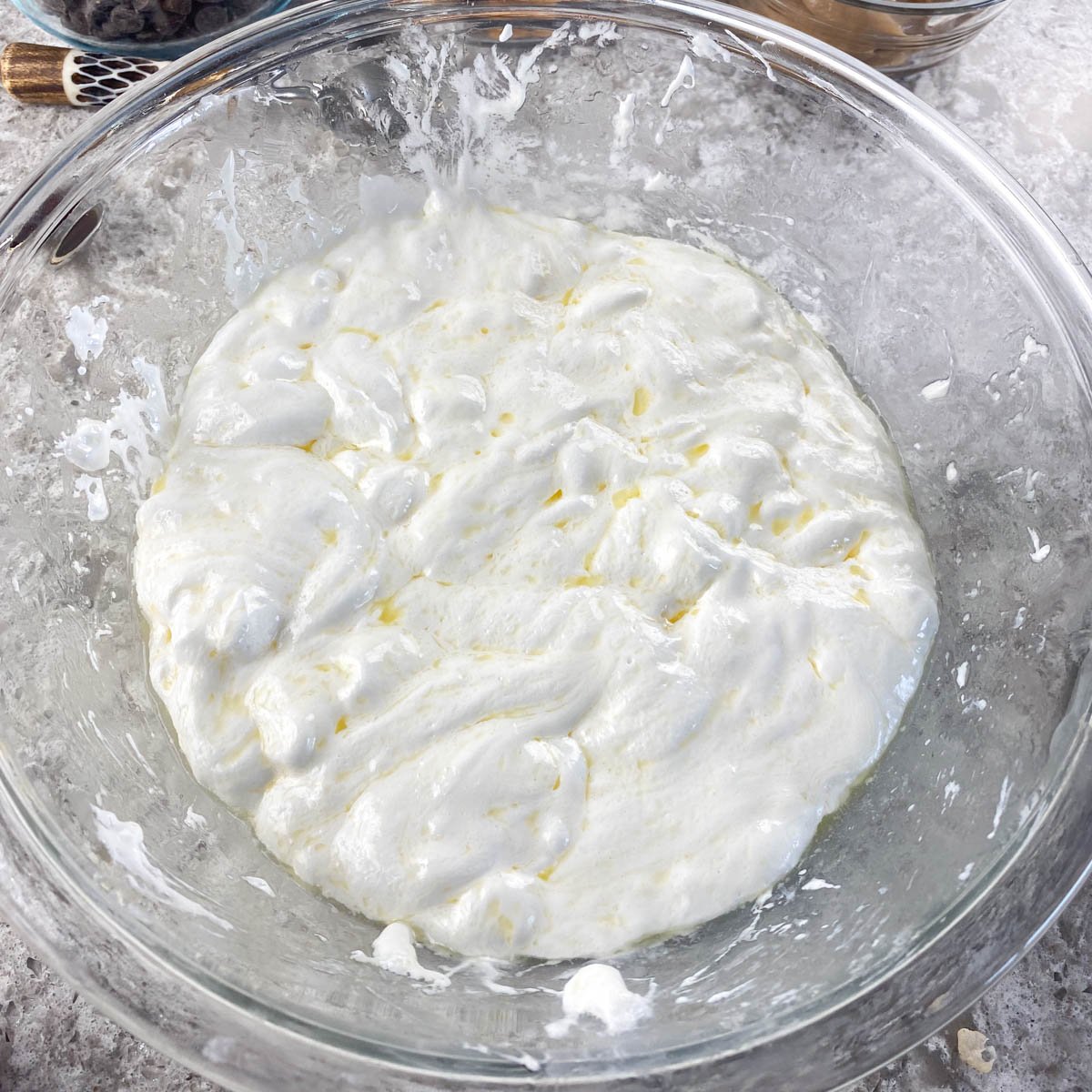 Glass bowl of melted marshmallows and butter.