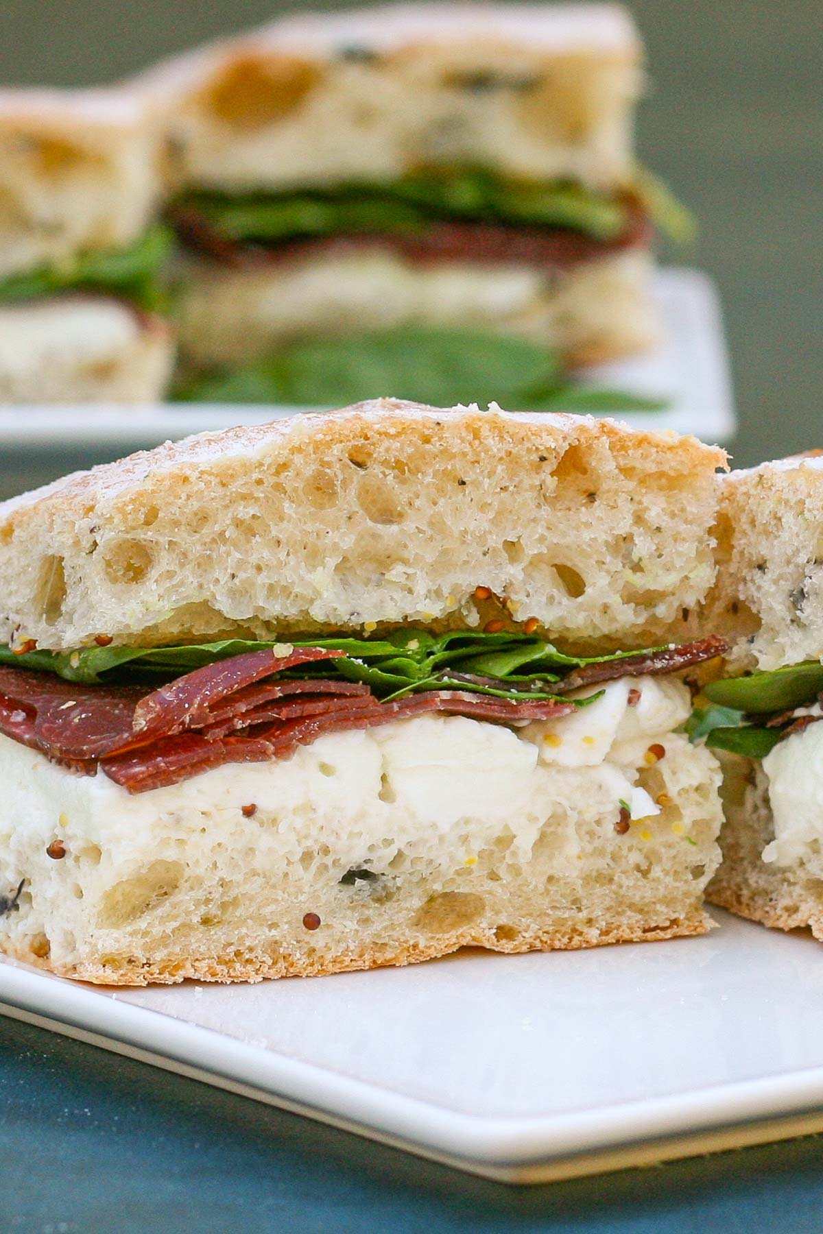 Italian style sandwich on white plate.