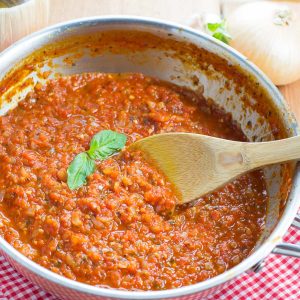 Homemade marinara sauce simmering in a skillet.