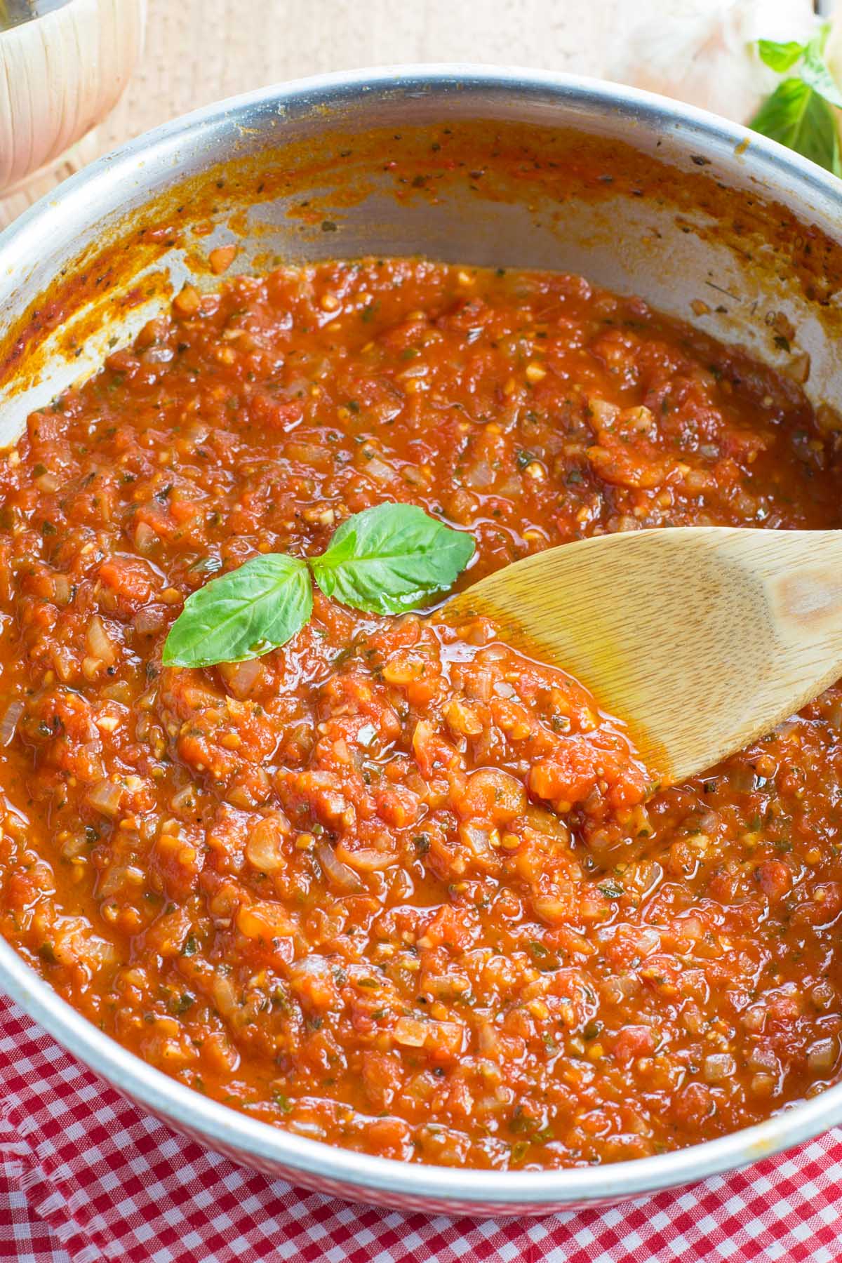 Homemade marinara sauce simmering in a skillet.