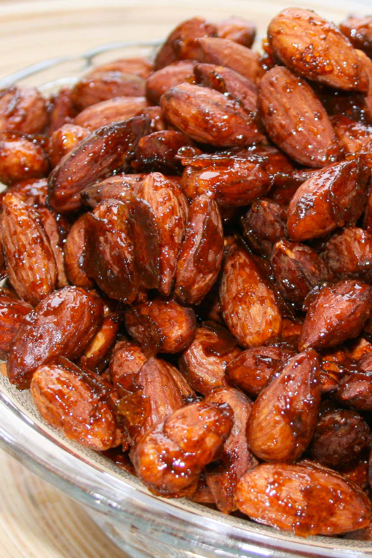 Bowl of roasted almonds coated in a glaze of honey and spices.