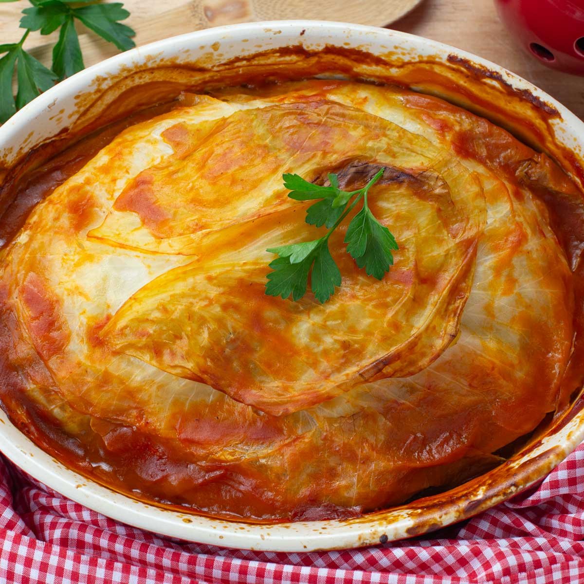 Red baking dish of baked turkey cabbage roll casserole.