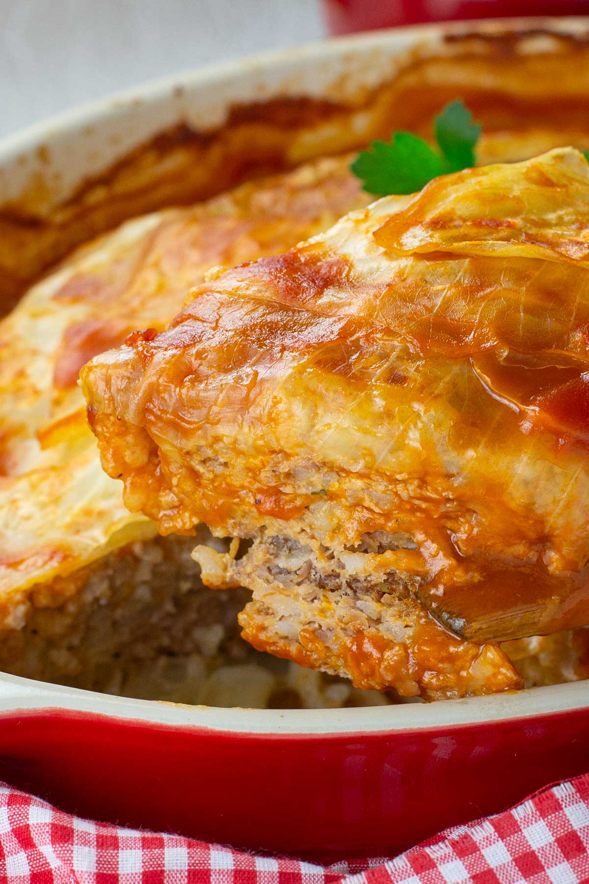 Red baking dish of baked turkey cabbage roll casserole.