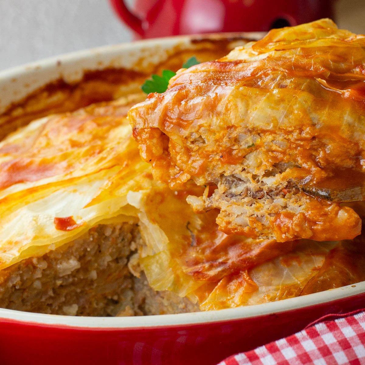 Red baking dish of baked turkey cabbage roll casserole.