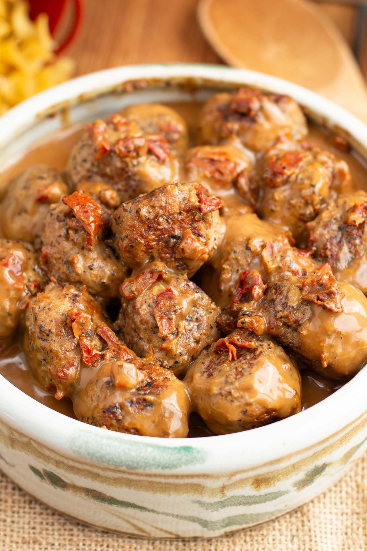 Serving bowl filled with turkey meatballs in a creamy sauce.