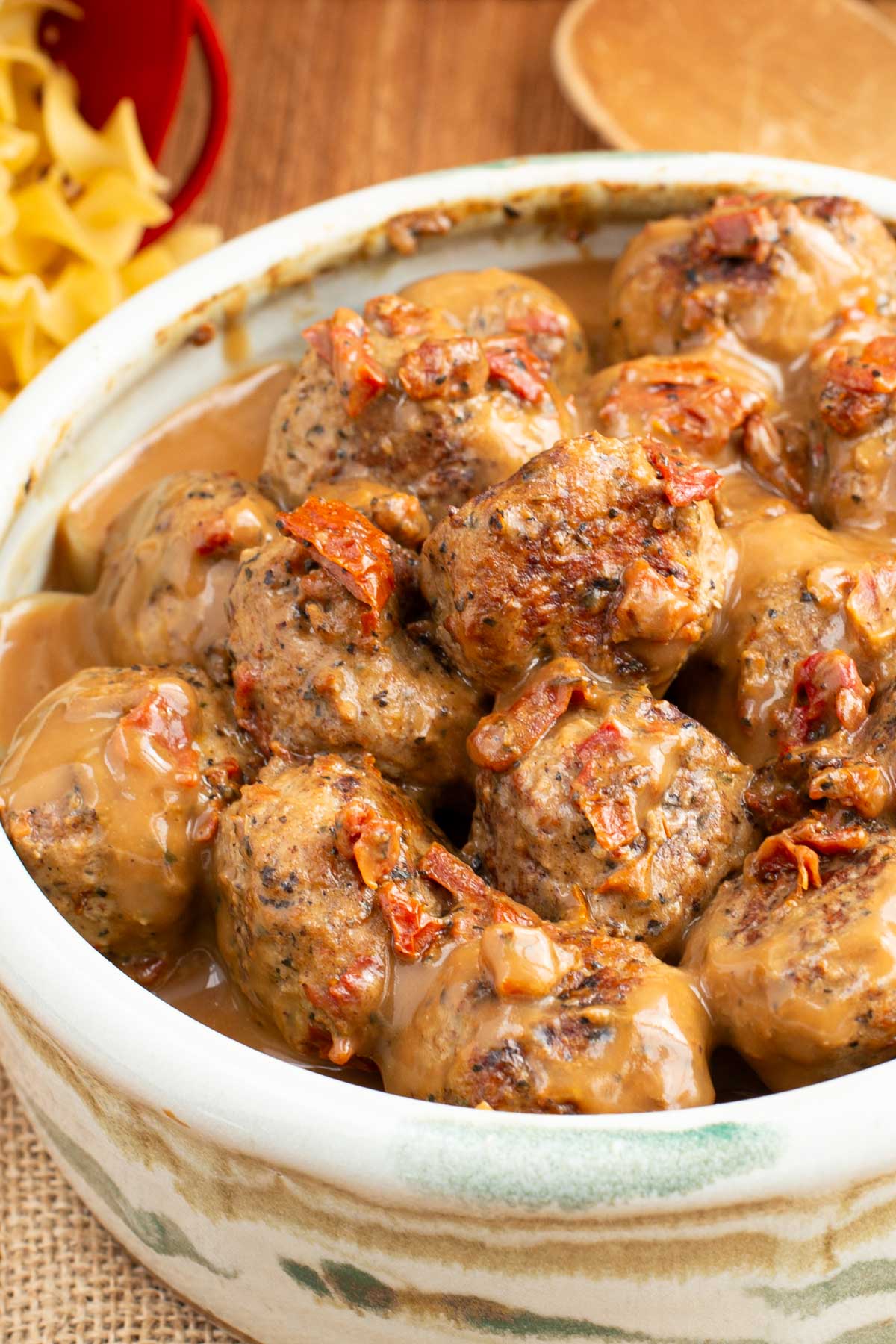 Serving bowl filled with turkey meatballs in a creamy sauce.