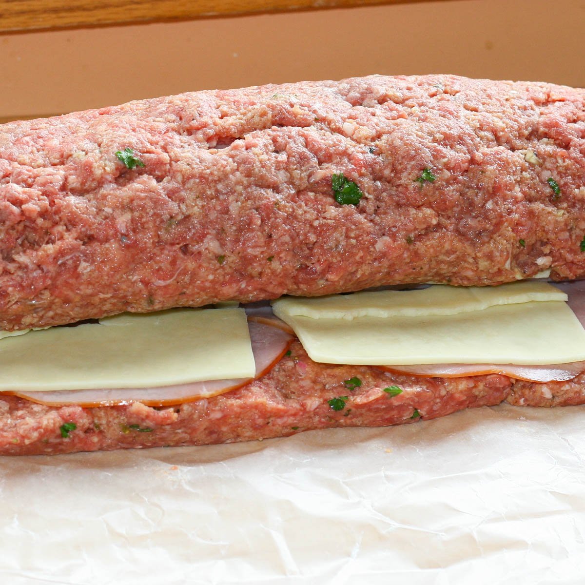Sicilian stuffed meatloaf rolled together with mozzarella and ham slices.