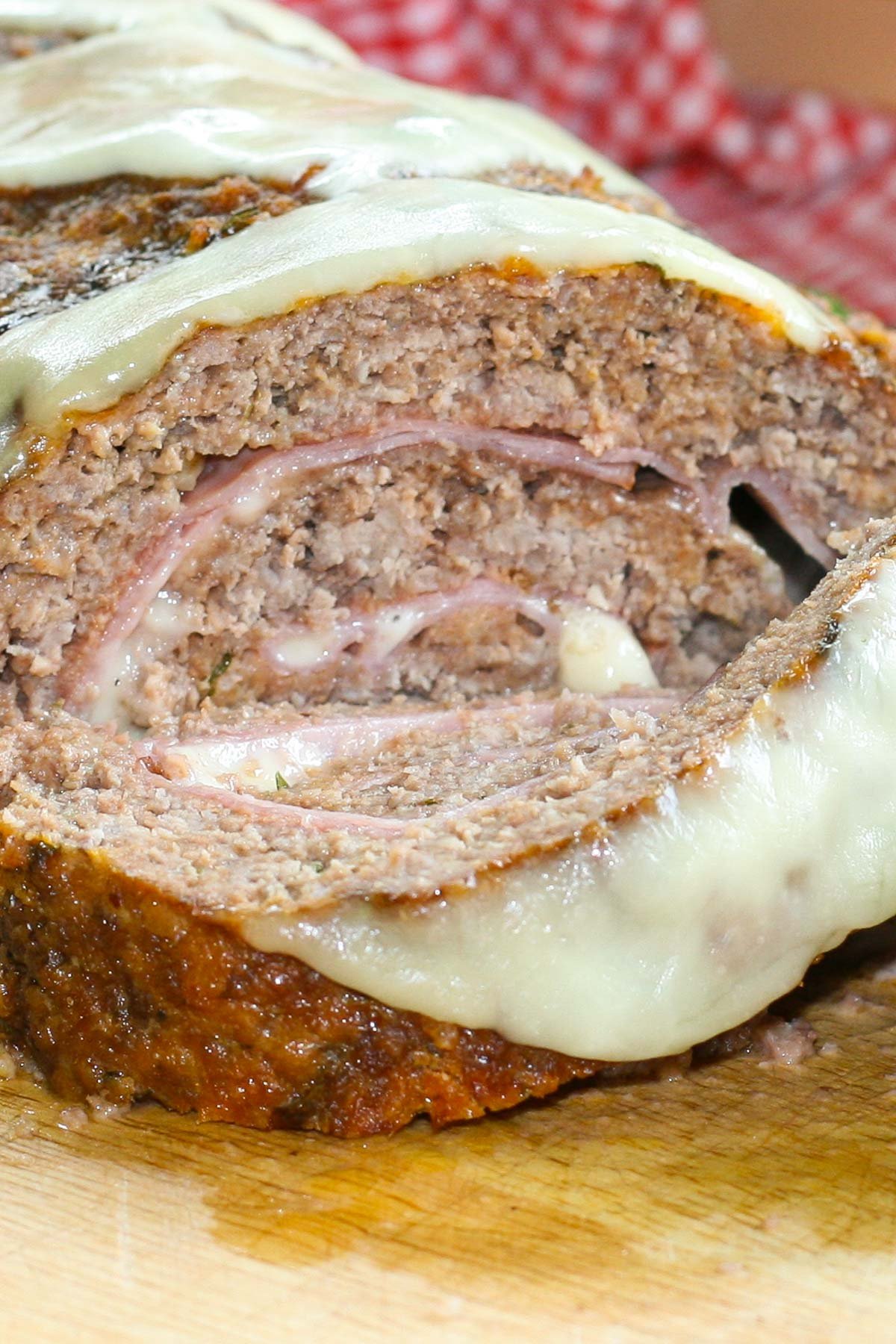 Baked meatloaf stuffed with ham and mozzarella cheese.