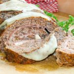 Baked meatloaf stuffed with ham and mozzarella cheese.