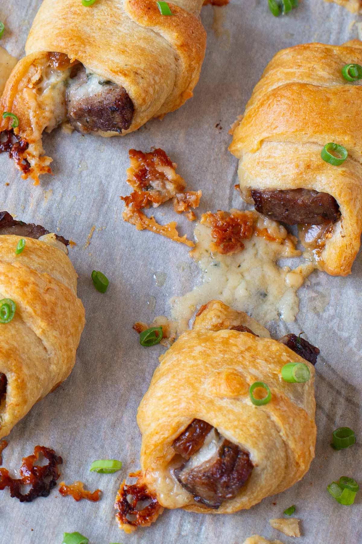 Appetizers of steak and blue cheese wrapped in crescent rolls.