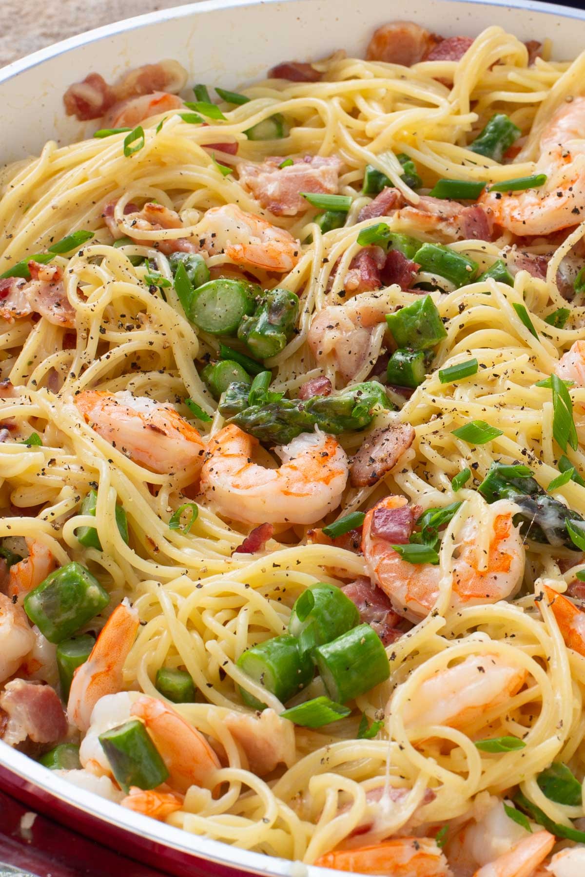 Skillet of spaghetti, shrimp and asparagus.