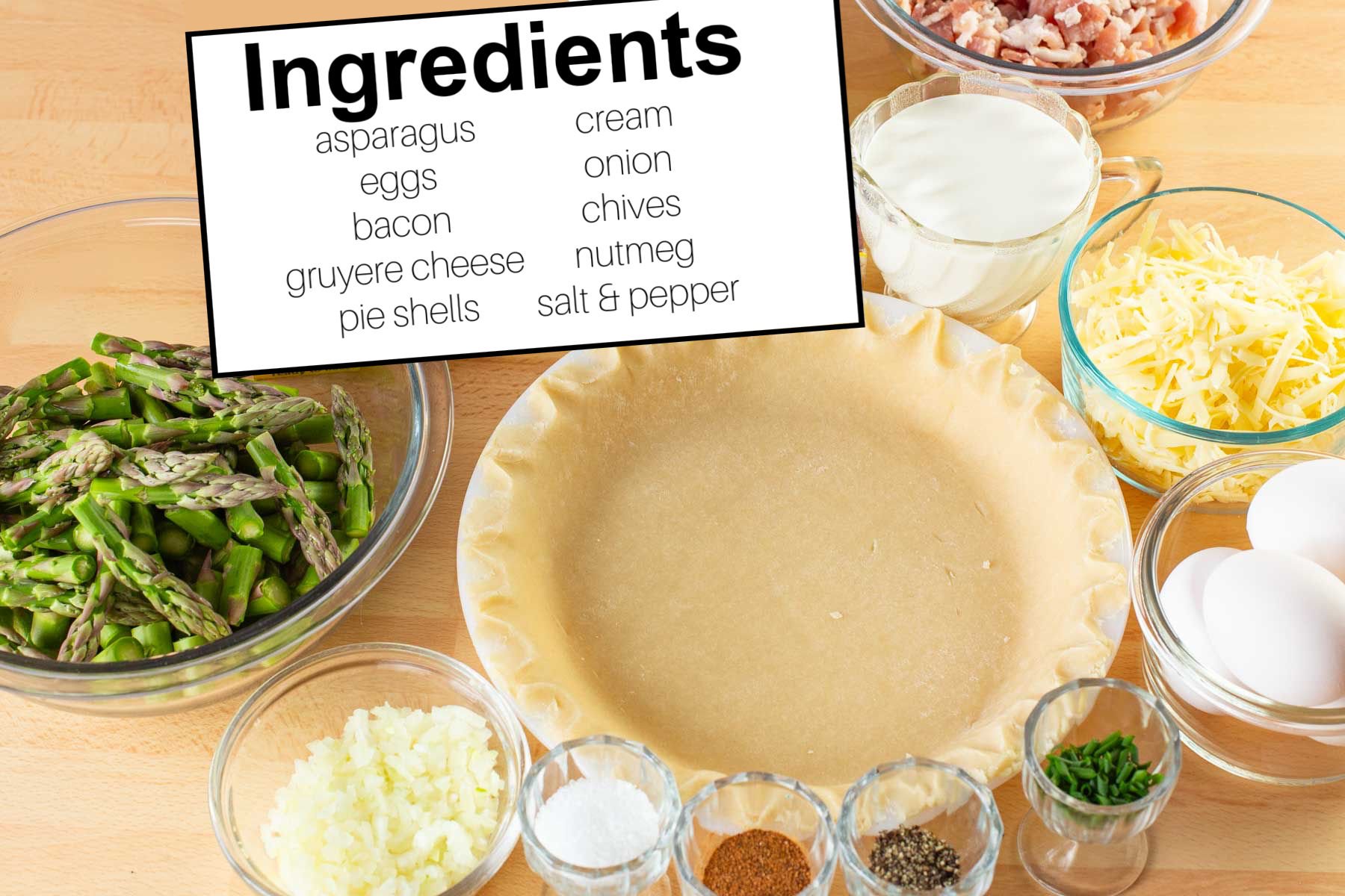 Ingredients measured in glass bowls for making quiche.