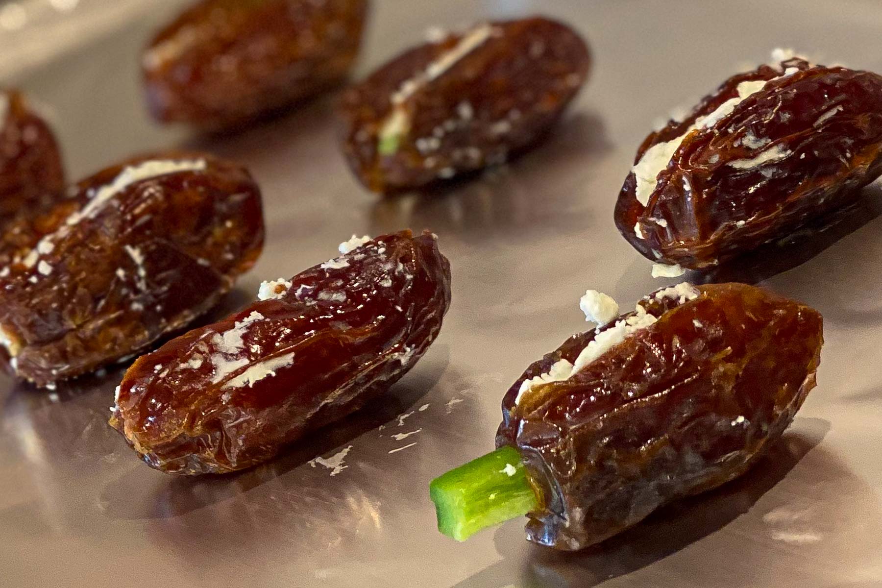 Dates stuffed with goat cheese and slice of jalapeños.