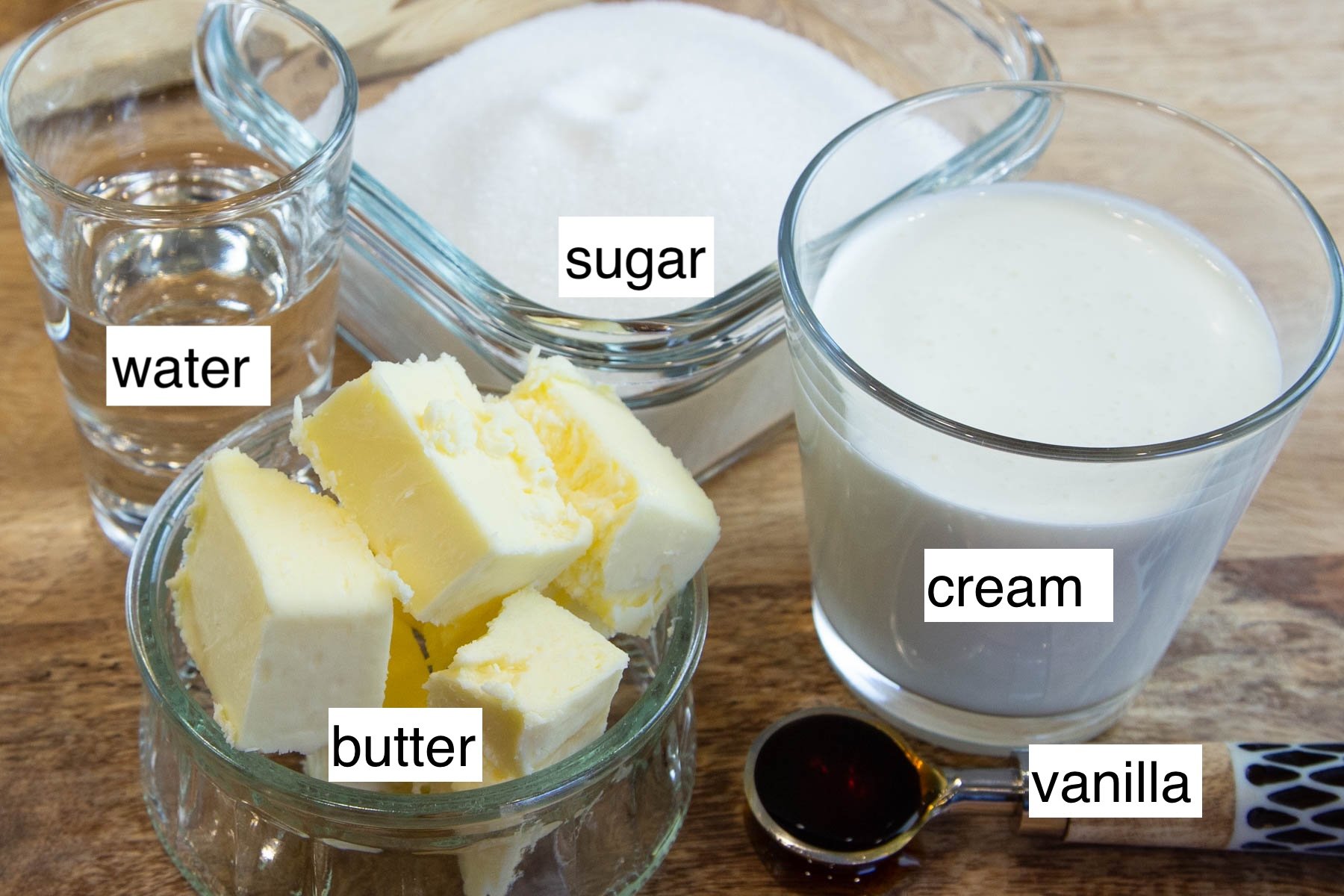 Ingredients measured and labeled for homemade caramel sauce.