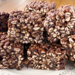 Stack of puffed wheat squares on a white decorative plate.