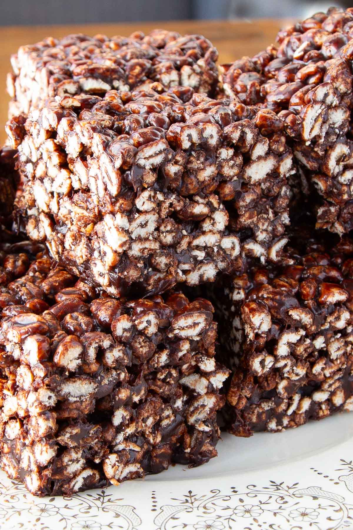 Stack of puffed wheat squares on a white decorative plate.